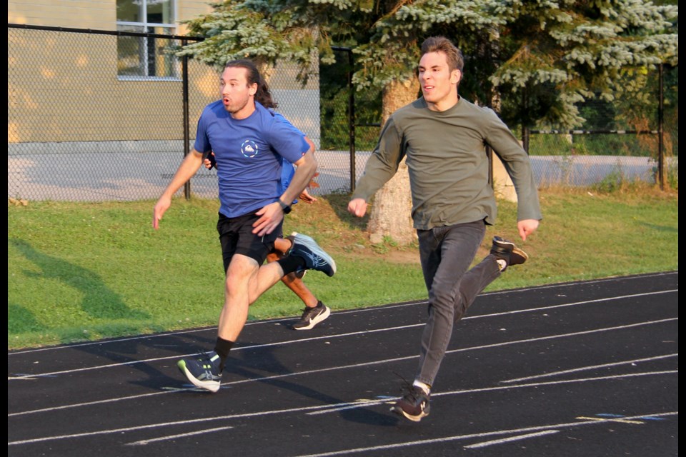 Two Huronia Huskies track athletes are seen training at St. Theresa's Catholic High School. 