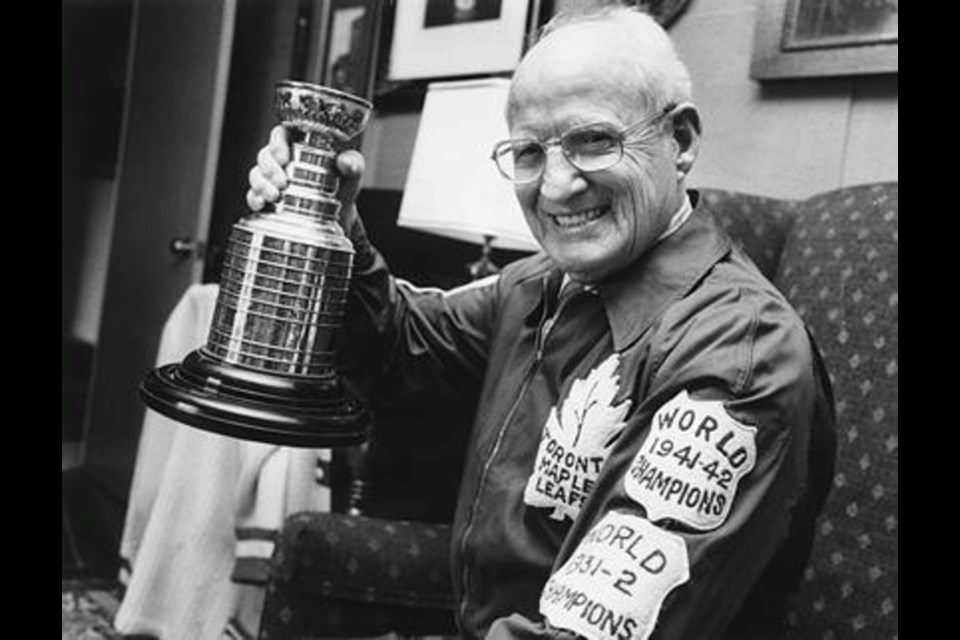 Hap Day is pictured with a replica Stanley Cup.