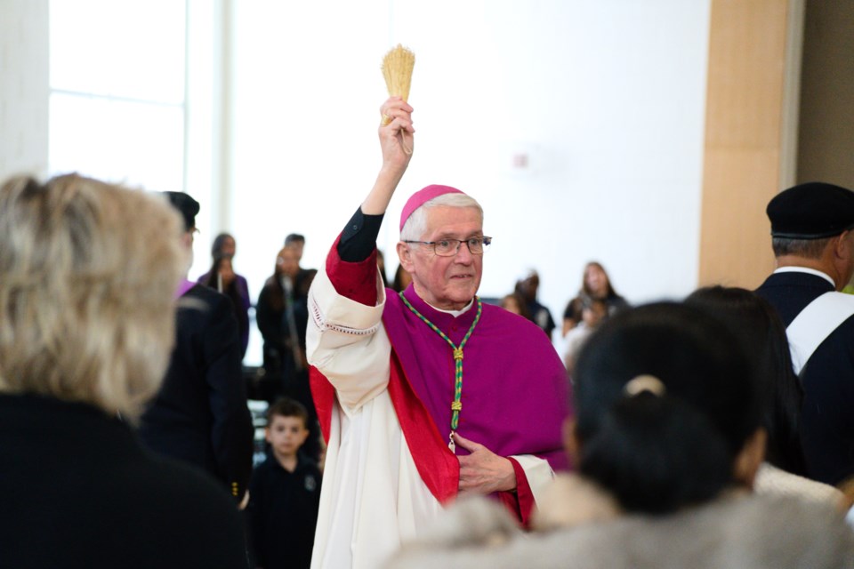 Bishop Douglas Crosby blesses the crowd.                               