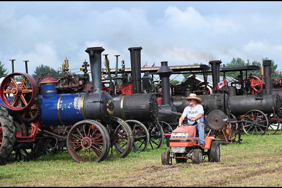 William Zimmerman cruises the 62nd annual Steam Era grounds aboard his '85 lawn tractor.