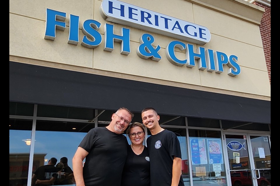 Thomas Grabowski and his family — Barbara and Matthew— pose outside Heritage Fish and Chips, which is closing its doors after 12 years of serving the Milton community.