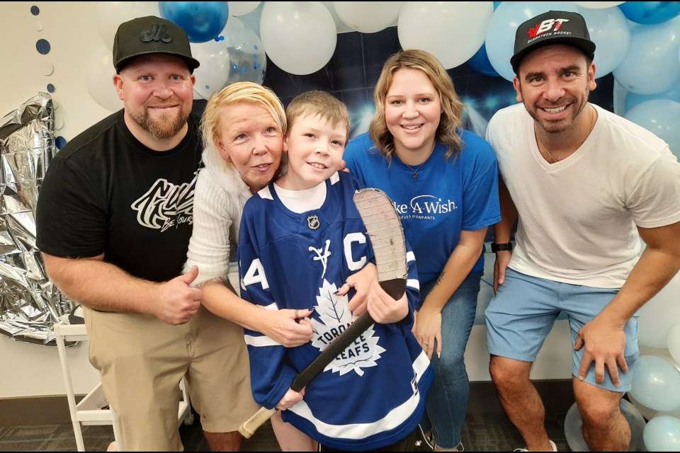 Liam Wilson and mom Deana join with Guby Customs' Peter 'Guby' Gubernator (left), Anthony Morra of BladeTech Hockey and Make A Wish coordinator Rachelle Courte at Liam's Make a Wish Reveal Party.