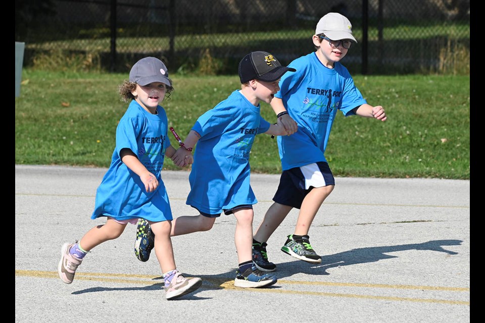 Four-year-old Riley Milec (left) joins Ezra Steeves, 6, and her brother Joshua, 6, as the trio run the 44th annual Terry Fox Run.