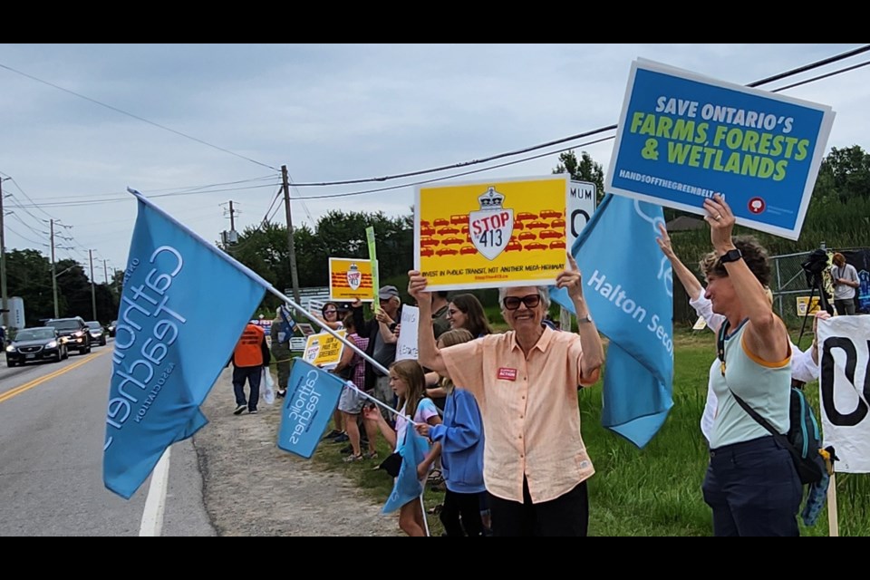 Protesters rally outside Country Heritage Park during Ford Fest Friday evening in Milton.