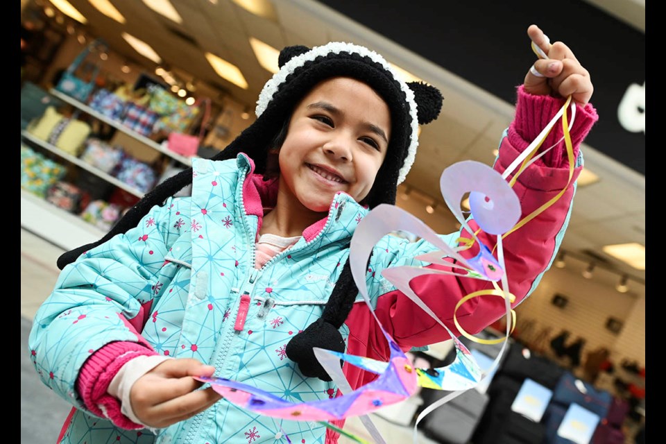 Six-year-old Aarvi Pradhan shows her Year of the Snake craft as part of Lunar New Year celebrations at Milton Mall Saturday.