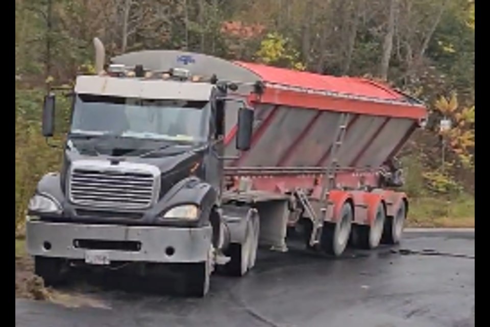 A fully-loaded truck gets stuck on a prohibited stretch of road in rural Milton.