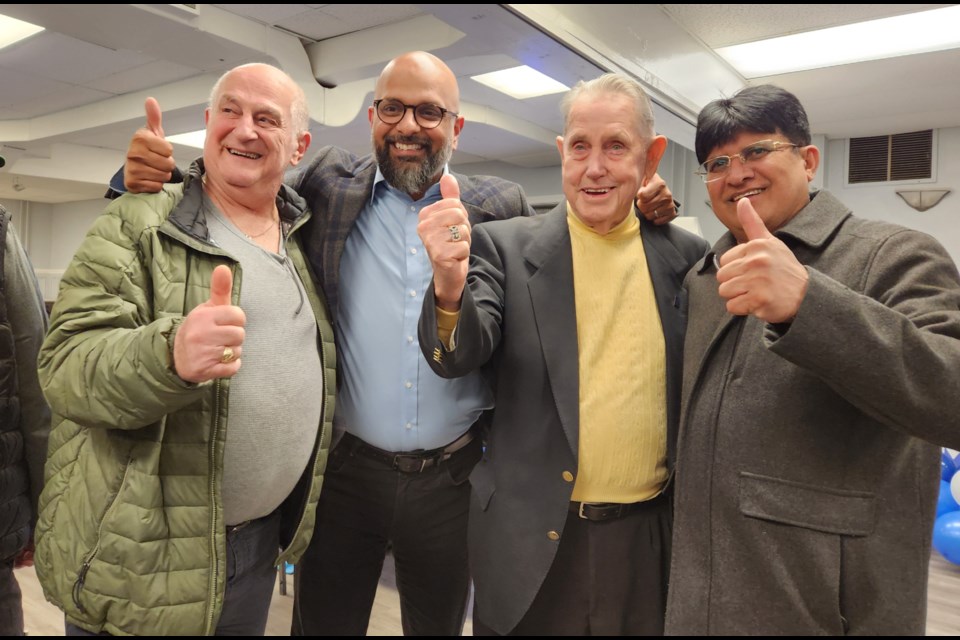 Zee Hamid (second from left) is all smiles while joined by his supporters during his reelection victory.