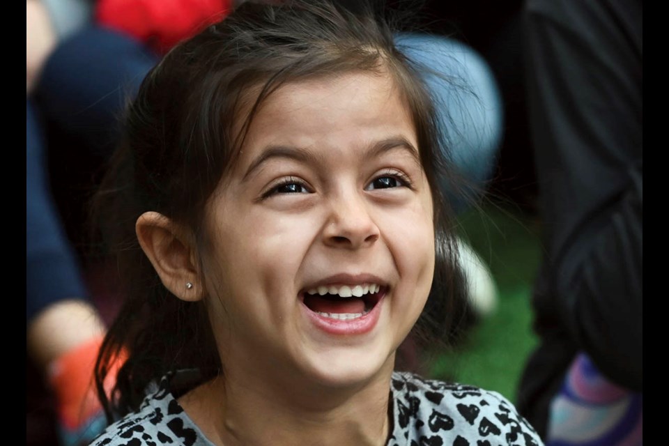 Naya Sanghera screams with laughter as she watches one of the illusions during the Magic Spectacular Show.