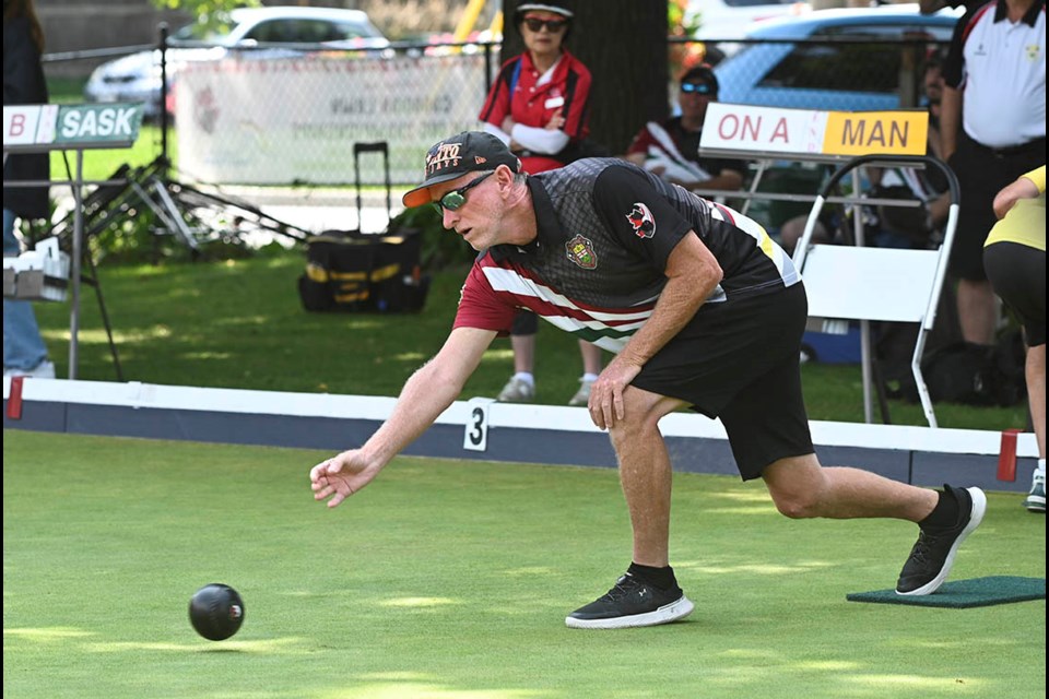 Peter Mutter with Team Ontario A lets a bowl go during the  men's pairs semifinals at the Canadian Lawn Bowling Championships.