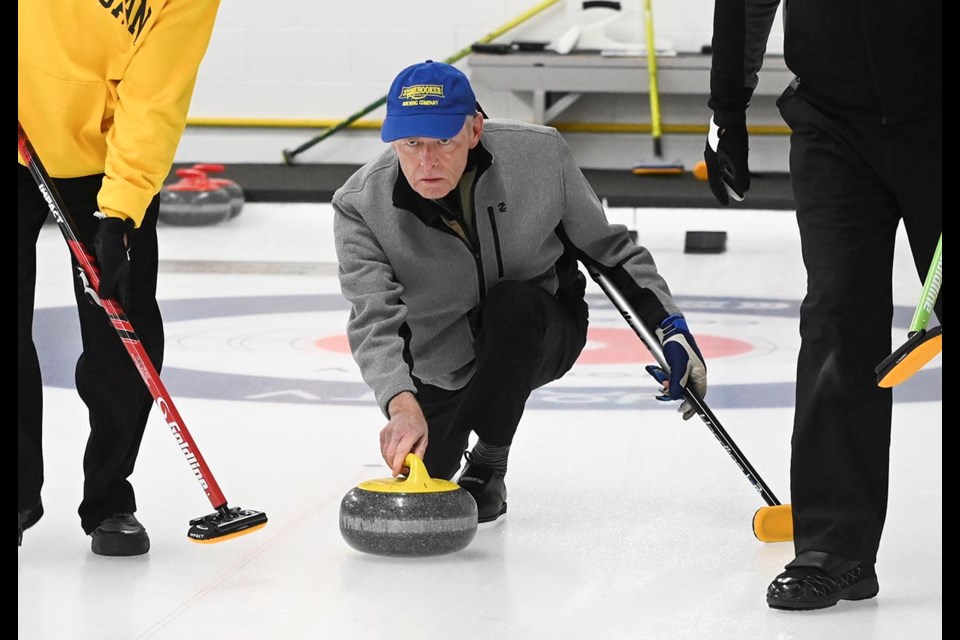 Milton Curling Club's Ken Armstrong lets a rock go during the MilkUP Diamond Skins bonspiel, part of the Milton Curling Club's 60th anniversary celebrations.