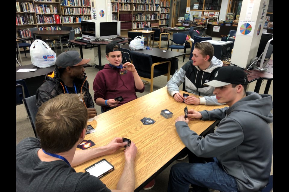 Nick Lamb and Phil Simms play the game The Mind at the end of the night. (supplied)