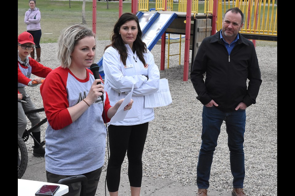 Megan Strube speaks about her experiences with muscular sclerosis as MS Walk organizer Amy Bosche and Moose Jaw mayor Fraser Tolmie look on.