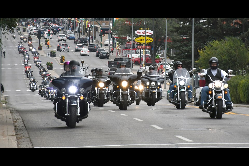 Riders in the Salvation Army Toy Run make their way up Main Street on Saturday afternoon.