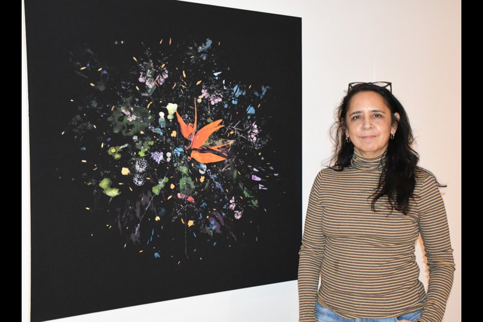 Artist Gabriela García-Luna stands near one of her paintings, which is part of the "Land-Water-Passages" exhibit in the Norma Lang Gallery at the Moose Jaw Museum and Art Gallery. Photo by Jason G. Antonio