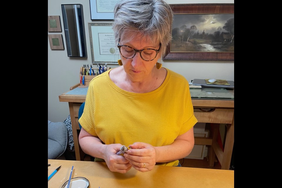 Jude Radwanski works on one of her jewelry creations at her home studio.