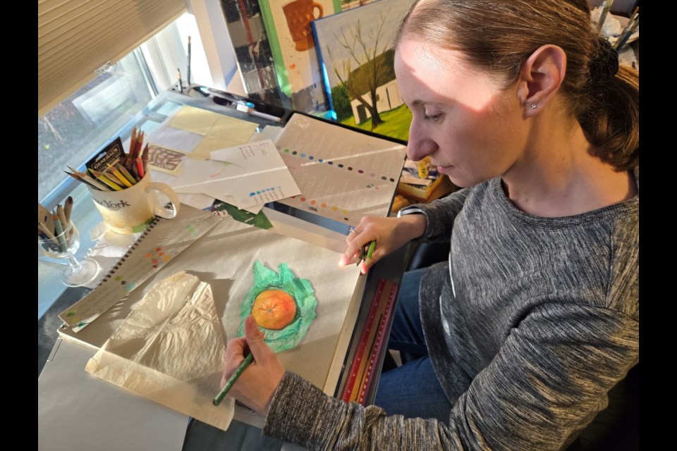 Artist Tanya MacKay works on one of her hyper-realist creations in her home studio.