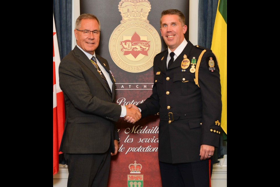 Lt.-Gov. Russ Mirasty presents the Saskatchewan Protective Services Medal to Staff Sgt. Cam Lewis during a ceremony at Government House. Photo submitted