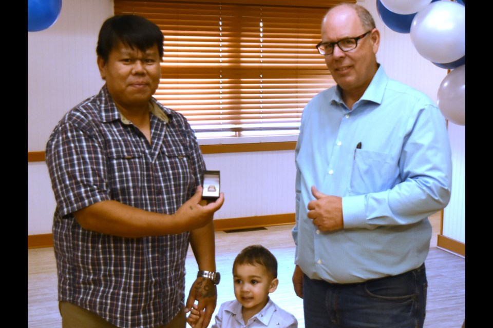 Driver Reynante Meremilla (left), accompanied by his son (centre), was recognized for five years and two months of service. "A dedicated hand that treats his truck like his own, and it shows," noted Reg Dyck (right).