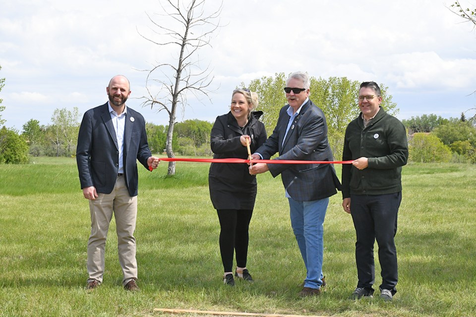 The cutting of the ribbon to open the Deja Vu Disc Golf Course. From left to right are Derek Blais, Director of Parks and Recreation, Leslie Campbell with the Sunningdale VLA Community Association, Mayor Clive Tolley, and Recreation Services Manager Scott Osmachenko.  