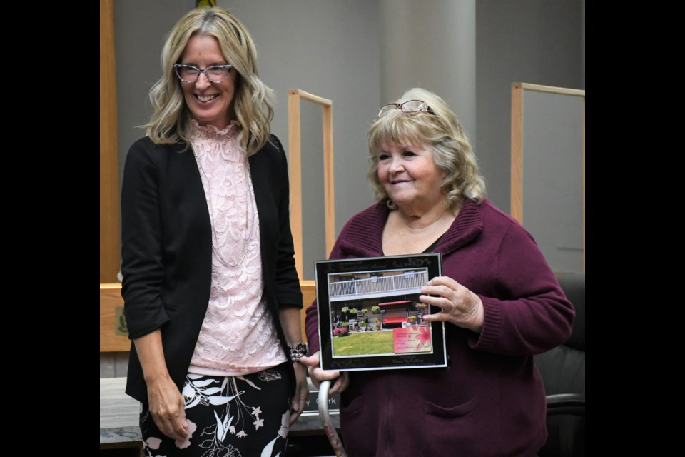 Acting Mayor Dawn Luhning presents an award to Karen McCubbing for having some of the best planters, during the 2021 Beautification Awards ceremony on Aug. 23. Photo by Jason G. Antonio 