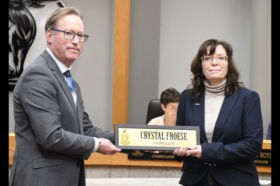 Mayor James Murdock presents former city councillor Crystal Froese with a framed nameplate from her council table position in honour of her service to residents. Photo by Jason G. Antonio