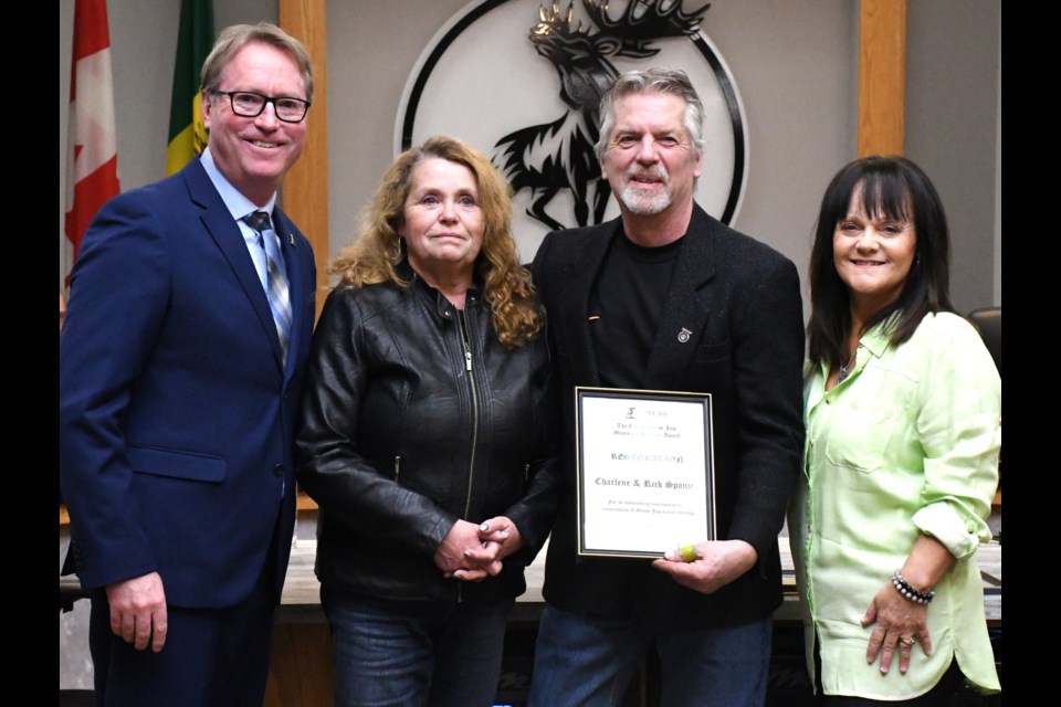 Mayor James Murdock (left) and Coun. Heather Eby (right) hand out The Restoration Award to Charlene and Rick Spanjer for their restoration of several historic buildings in the Avenues. Photo by Jason G. Antonio