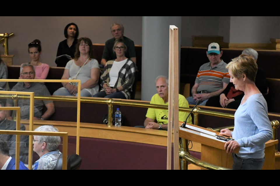 Shelley Hill (right, at podium) speaks to council about one-sided parking in the avenues, while her neighbours watch in the gallery. Photo by Jason G. Antonio 