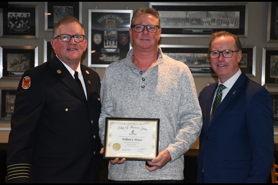 Bill Howes (middle) is congratulated on his retirement after 35 years, flanked by Fire Chief Rod Montgomery and Mayor James Murdock. Photo by Jason G. Antonio