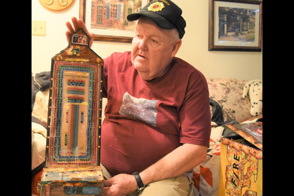 Neil Puckett has created a cribbage board that looks like a grain elevator on fire. It took him 85 hours to complete the project. Photo by Jason G. Antonio