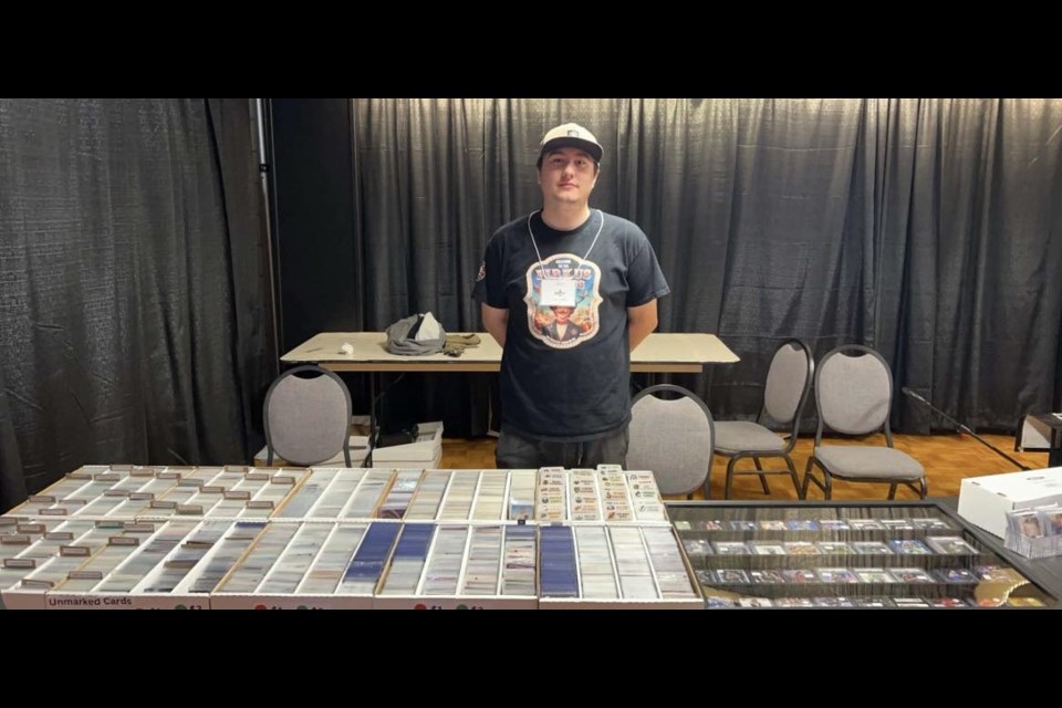 One of the entrepreneurs with Living Sky Collectibles showcases the group's many cards during a trade show.