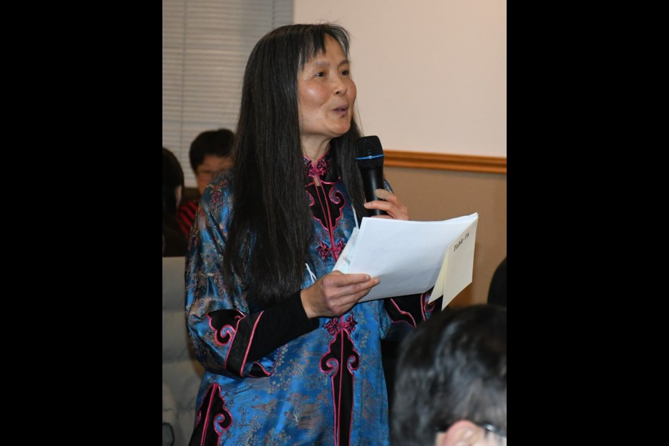 Judy Quon welcomes people to the  Chinese New Year celebration. Photo by Jason G. Antonio