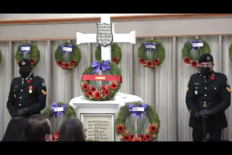 Members of the Saskatchewan Dragoons stand sentinel at the Remembrance Day service cenotaph.