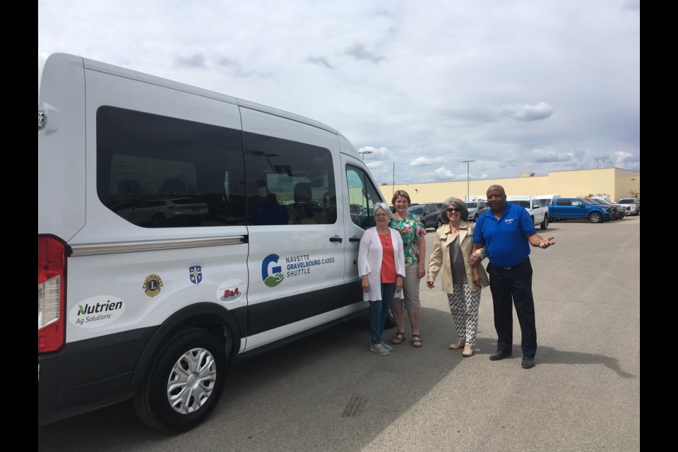 Gravelbourg Cares Shuttle Service project co-ordinators and directors — Linda Roberts, Betty Hawkins and Lynn Holmes — and Bryan McBean, sales manager with Moose Jaw's Knight Ford Lincoln, gather with the new van that that dealership helped find for the charitable organization. Photo courtesy Facebook