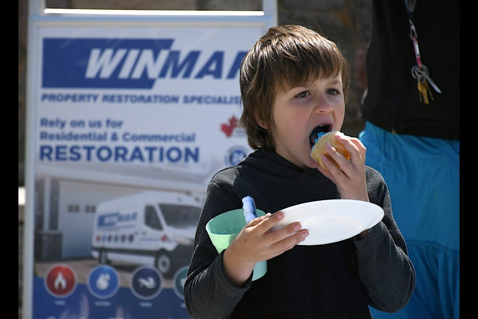 A youngster enjoys a birthday cupcake during Willy WINMAR’s birthday celebration.