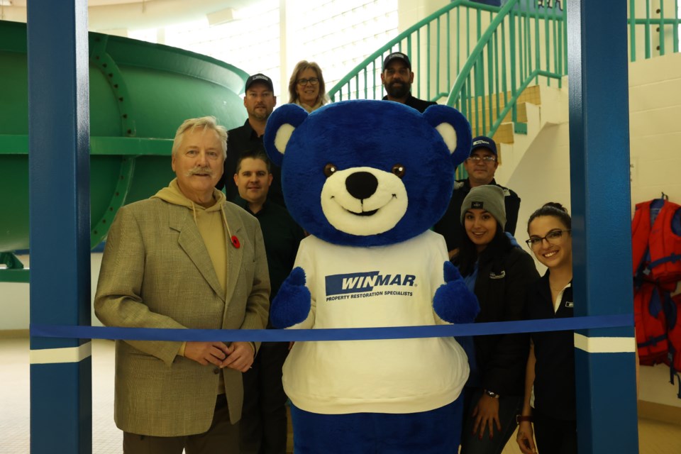 Mayor Clive Tolley, Willy Winmar, and representatives of Winmar Moose Jaw are overjoyed for the ribbon-cutting ceremony in recognition of their sponsorship agreement for naming rights of the waterslide at Kinsmen Sportsplex 