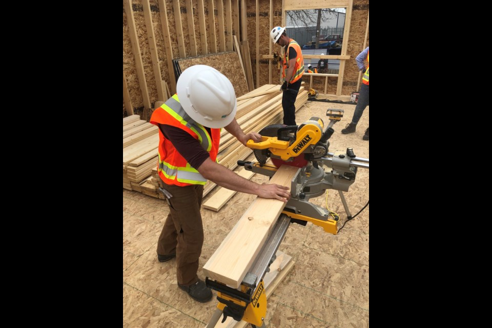 SaskWater employees Chad Braun and Jay Rockey help construct a Habitat home on Ominica Street on May 10, as part of the Crown corporation’s community outreach initiative. Photo courtesy Courtney Mihalicz