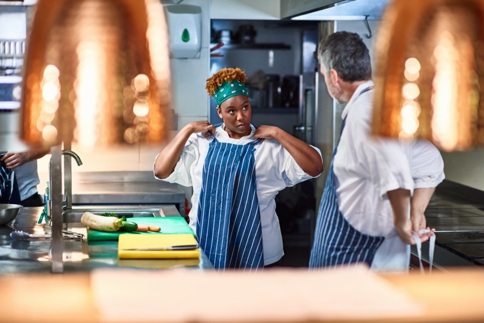 Female black chef listens to college in professional kitchen (10'000 Hours-DigitalVision-Getty Images)