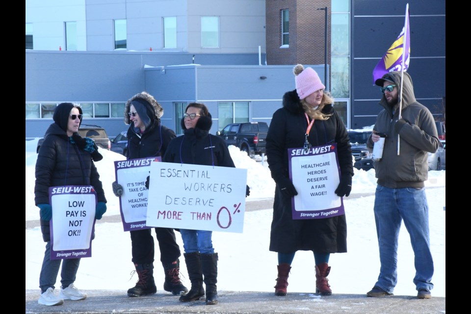 Health-care employees stand in front of Dr. F.H. Wigmore Regional Hospital during their "information picket" to educate residents about how they have not had a contract in nearly two years. Photo by Jason G. Antonio