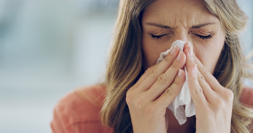 woman sneezing allergies getty images