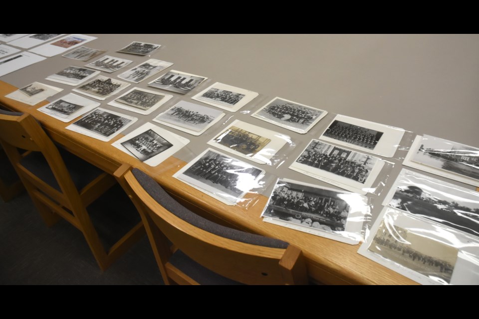 A table in the Moose Jaw Public Library archives department features many historical pictures about the Moose Jaw Band — and later, Choral — Festival. Photo by Jason G. Antonio