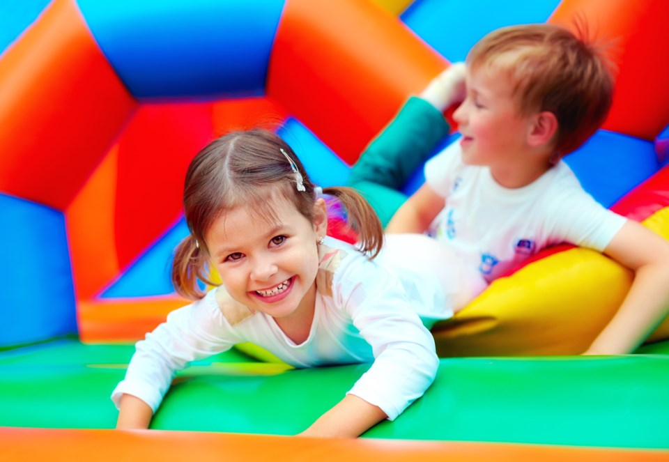 kids playing in bouncy castle shutterstock