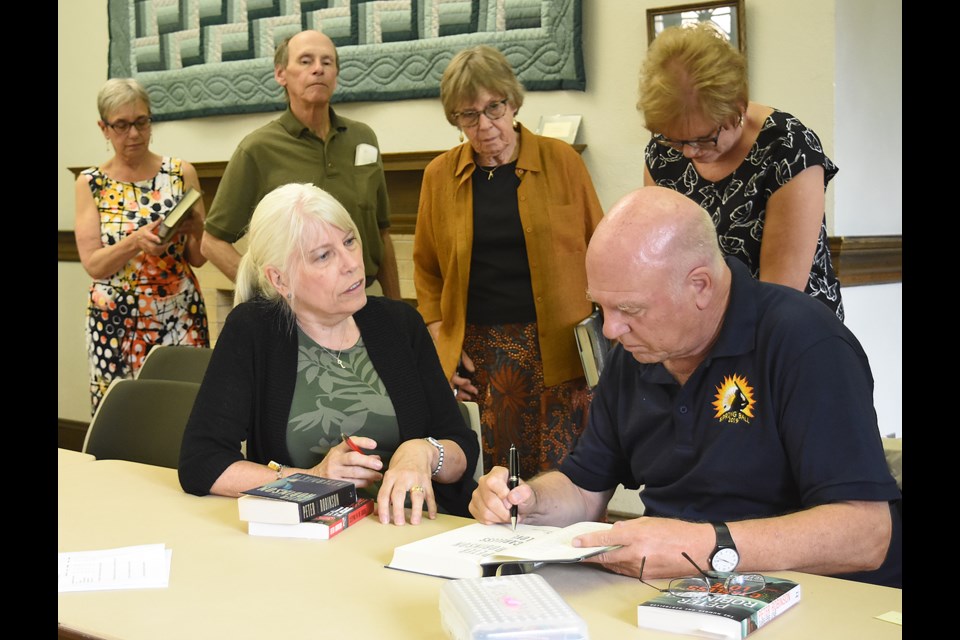 Peter Robinson, author of the Inspector Banks series, including the most recent novel Careless Love, signs copies of his books for Festival of Words participants.