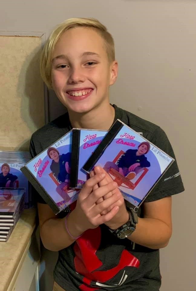 Lil Poomba with his CDs (from Facebook)