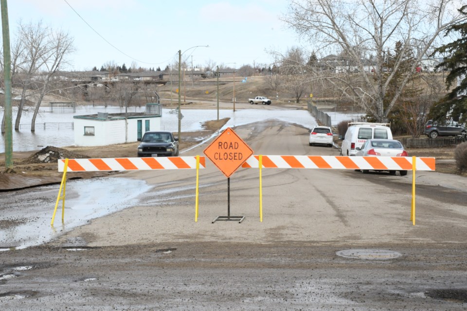 A barricade blocks the entrance to Fourth Avenue Northwest at Macdonald Street. Another barricade is at the Thatcher Drive NW entrance. Photo by Jason G. Antonio