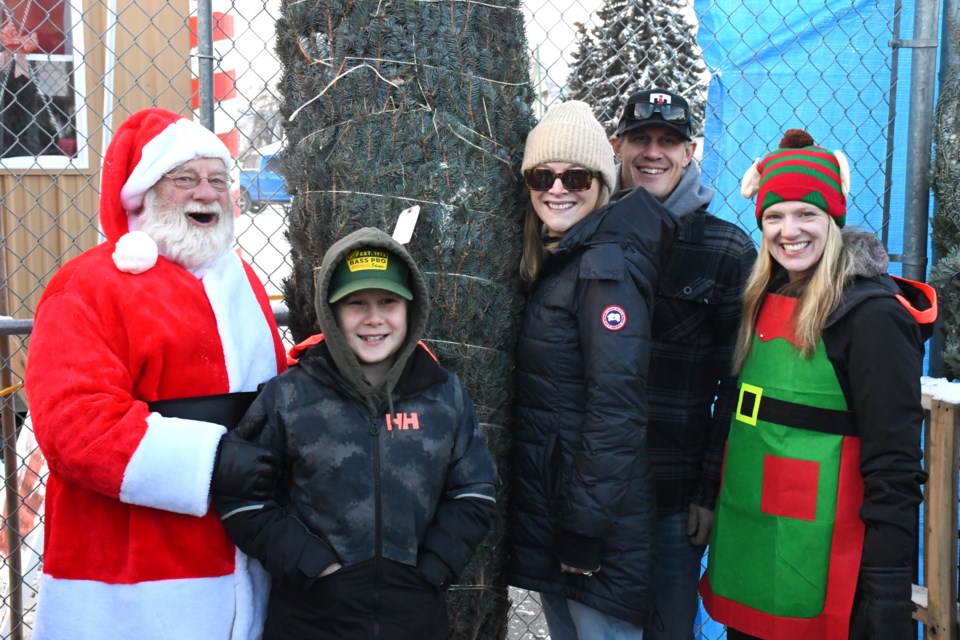 Santa Claus takes a break from his busy holiday schedule to help families choose the perfect Christmas tree and take a family photo on Nov. 30.