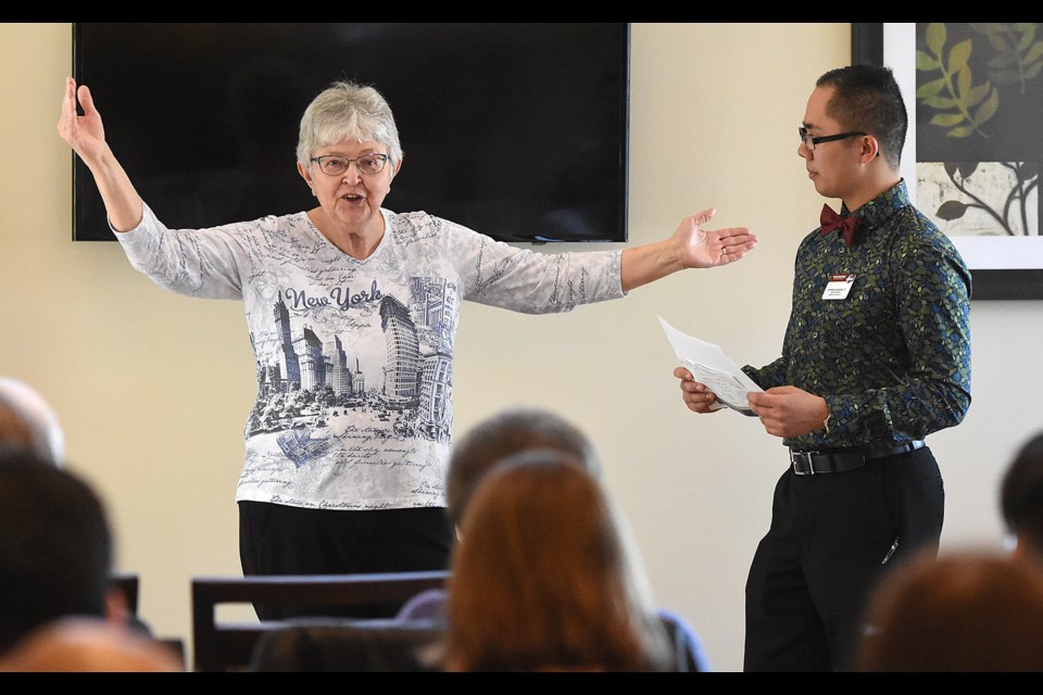 Margaret Ustupski gestures while answering a question from Toastmasters contest chair Geremy Quiambao during the Area competition in March.