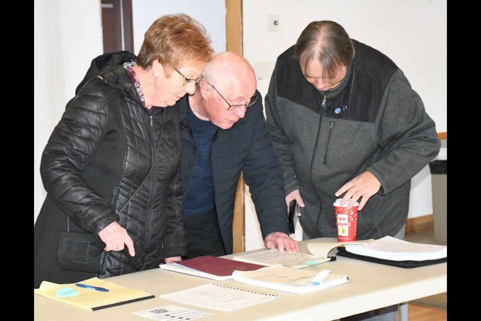 Residents look through a history book of the valley showing archaeological sites. Photo by Jason G. Antonio