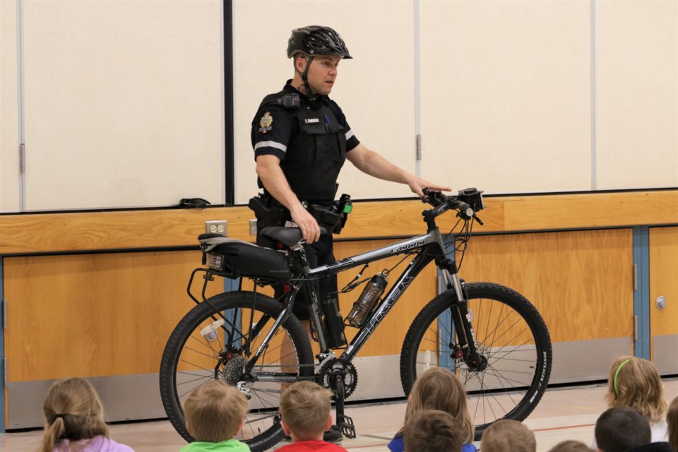 Cst. Kyle Cunningham of the MJPS highlights the different parts of the bike. (Scott Hellings photo)