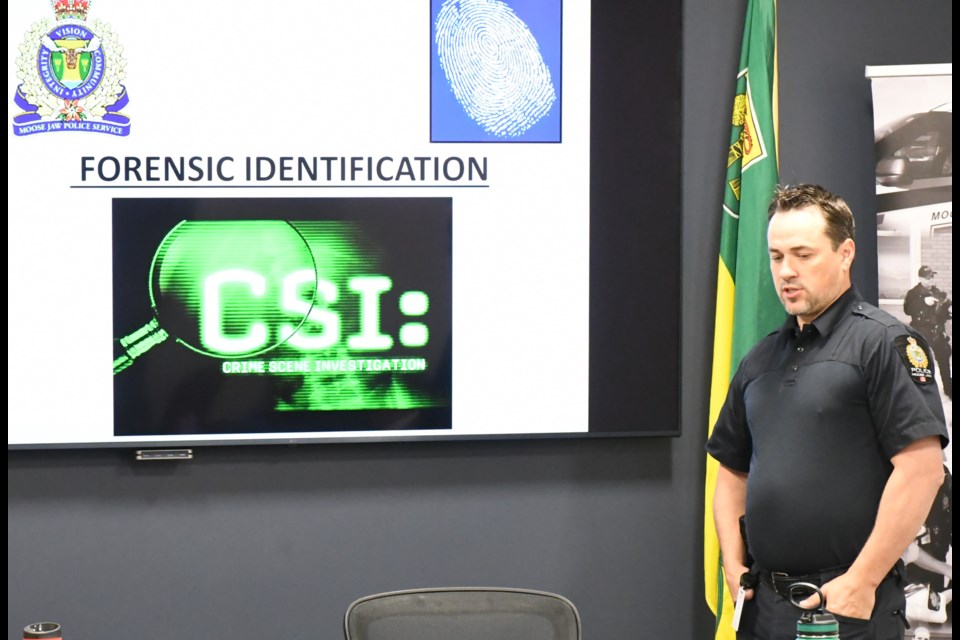 Const. Evan Schwabe speaks to the Board of Police Commissioners about the police service's forensic identification unit. Photo by Jason G. Antonio