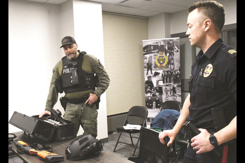 Staff Sgts. Chad Scheske and Taylor Elder speak to the police board about the tactical response team. Photo by Jason G. Antonio